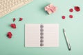 Blank notepad with pen, computer keyboard. gift box and red spring flowers on teal blue background. Top view, flat lay Royalty Free Stock Photo