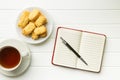 Blank notepad with pen and cookies with tea. Royalty Free Stock Photo