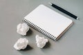 Blank notepad, pen and crumpled paper on office desk Royalty Free Stock Photo