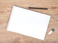 Blank notepad, pencil and eraser on the wooden table Royalty Free Stock Photo