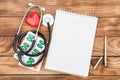 Blank notepad with stethoscope, pills and red heart on the table. Medical concept. Top view. Space for text Royalty Free Stock Photo