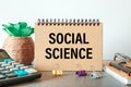 Blank notepad with text Social Science on an office desk Royalty Free Stock Photo
