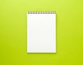 Blank notepad white page on green desk, color background. Top vi