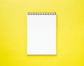 Blank notepad white page on yellow desk, color background. Top v