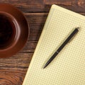 Blank notepad on a wooden table