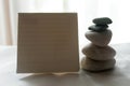 Blank notepaper for your text with still life concept of the balancing white stones on the white background. Royalty Free Stock Photo