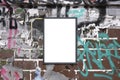 Blank notice board on rough graffiti covered urban brick wall for customisation and mockup