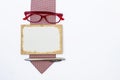 Blank old card with red eyeglasses and silver pen on red necktie