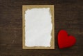 Blank old paper card and red heart on vintage wood background Royalty Free Stock Photo