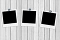 Blank old photos on clips on white wooden Royalty Free Stock Photo