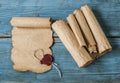 scrolls of old paper on a wooden table. Antique background Royalty Free Stock Photo