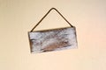 Blank old wooden sign hanging crooked on wall Royalty Free Stock Photo