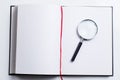 Blank open book and magnifying glass Royalty Free Stock Photo