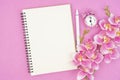 The blank open notebook and clock with pink color orchid for your text or message Royalty Free Stock Photo