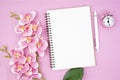 The Blank open notebook and clock with pink color orchid for your text or message Royalty Free Stock Photo