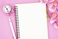 The blank open notebook and clock with pink color orchid for your text or message Royalty Free Stock Photo