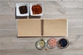 Blank open notebook for notes and pepper, bay leaf, rosemary, onions, Himalayan salt, olive oil, soy sauce on a w Royalty Free Stock Photo