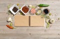 Blank open notebook for notes and pepper, bay leaf, rosemary, onions, Himalayan salt, olive oil, soy sauce on a w Royalty Free Stock Photo