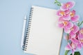 The blank open notebook and pen with pink color orchid for your text or message Royalty Free Stock Photo