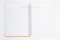 Blank and open white spiral notebook with an orange cover, with copy space Royalty Free Stock Photo