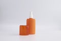 Blank orange skincare pump open the cap mock up on background for UV protection product with copy space