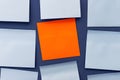 Blank orange sticky sticker among blue note papers. Important message or reminder, copy space Royalty Free Stock Photo