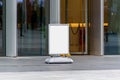 The blank outdoor whiteboard at a sidewalk near the business center, restaurants advertising