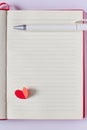 Blank page in notebook, pen and red paper heart Royalty Free Stock Photo