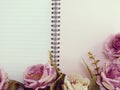 Blank page of notebook and pink flower background Royalty Free Stock Photo