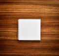 Blank page of spiral notebook on wooden floor background. Royalty Free Stock Photo