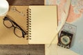 A blank page spread out on a wooden table Side map, feather pen, coffee mugs, compass, glasses and antique keys. Evening sun Royalty Free Stock Photo