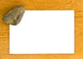 Blank pape and rock on wooden bords Royalty Free Stock Photo