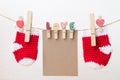 Blank paper with baby socks hanging on love clothesline Royalty Free Stock Photo