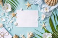 Blank paper on blue pastel background with shells and starfish, empty note for holidays on beach Royalty Free Stock Photo