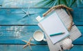 Blank paper on blue pastel wooden background with shells and starfish, empty note for holidays on beach Royalty Free Stock Photo