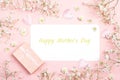 Blank paper card with gypsophila flowers and gift box on pink ba Royalty Free Stock Photo
