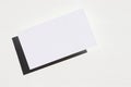 Blank paper card on white background. Mockup invitation on white desk. Top view, copy space. Royalty Free Stock Photo