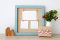 Blank paper cards hanging on blue vintage wooden frame and gift Royalty Free Stock Photo