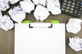 Blank paper clip on clipboard with paper ball and calculator Royalty Free Stock Photo