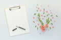 Blank paper on clipboard note pad with floral decoration Royalty Free Stock Photo