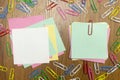 Blank paper frames, reminder in the centre and colorful paper pins around on wooden desk Royalty Free Stock Photo