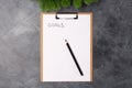 Blank paper with goals title and black pencil on grey table. Flat lay. Top view. New year concept. Royalty Free Stock Photo