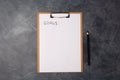 Blank paper with goals title and black pencil on grey table. Flat lay. Top view. New year concept. Free space. Copy Royalty Free Stock Photo