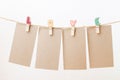 Blank paper hanging on love clothesline with white background Royalty Free Stock Photo