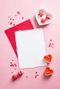Blank paper mockup, sweets, candles on pink table. Happy Valentines Day concept Royalty Free Stock Photo