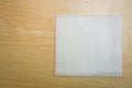 Blank paper napkin isolated on wooden background with copy space . White napkin on wooden background, many views of white napkins Royalty Free Stock Photo