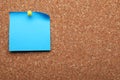 Blank paper note pinned to cork background. Space for text Royalty Free Stock Photo