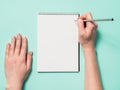 Blank paper notebook and female hands with pencil Royalty Free Stock Photo