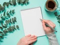 Blank paper notebook and female hands with pencil Royalty Free Stock Photo
