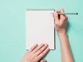 Blank paper notebook and female hands with pencil Royalty Free Stock Photo